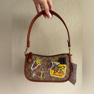 COSMIC COACH SWINGER 20 IN SIGNATURE CANVAS WITH PATCHES